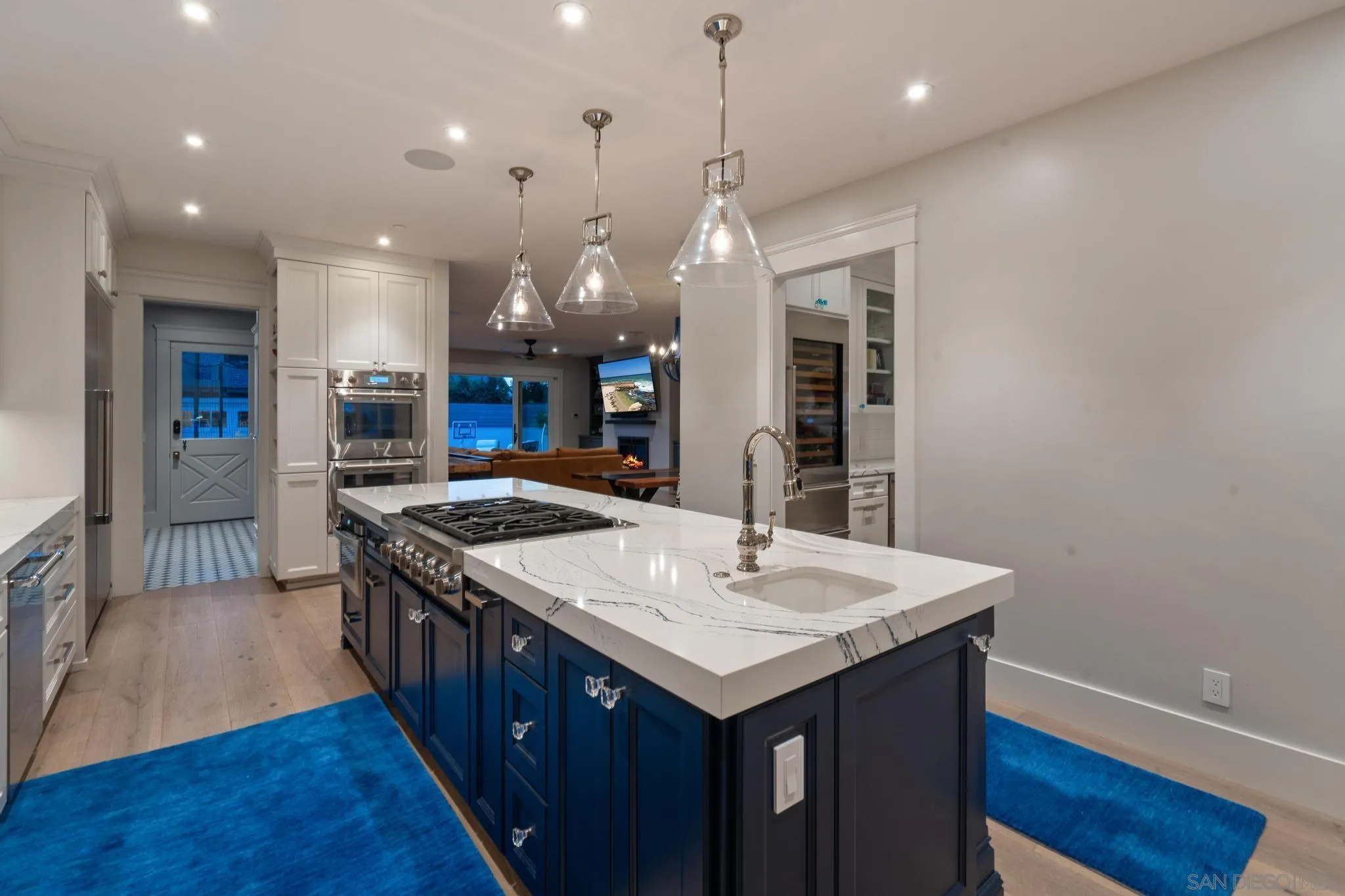 1027 G Avenue Coronado, CA 92118 - Photo 15 of 59 a kitchen with center island wooden floor and a view of living room