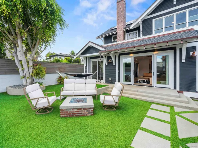 a living room with furniture a flat screen tv and gym equipment