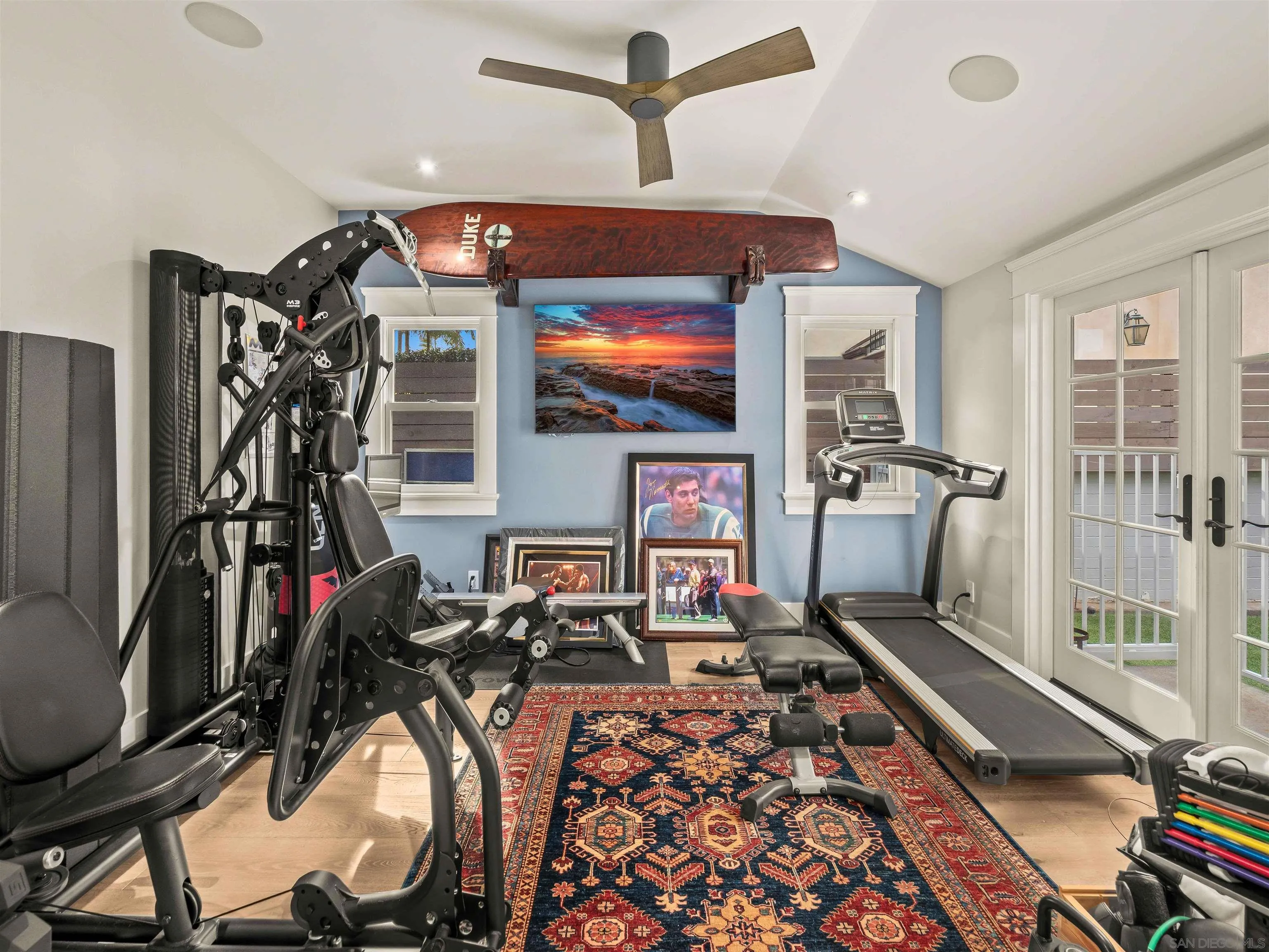 1027 G Avenue Coronado, CA 92118 - Photo 33 of 59 a living room with furniture a flat screen tv and gym equipment