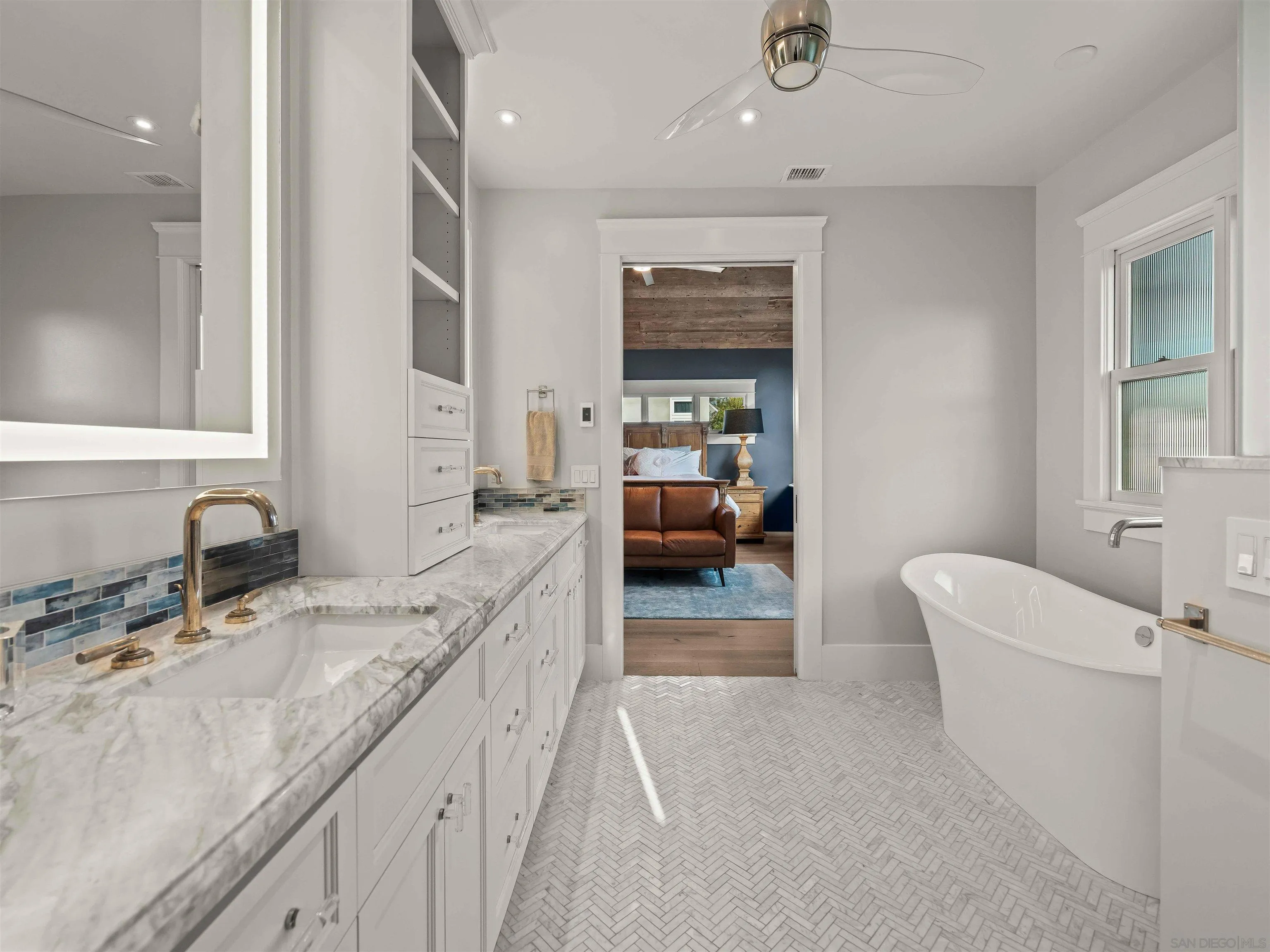 1027 G Avenue Coronado, CA 92118 - Photo 41 of 59 a bathroom with a double vanity sink a mirror and a bathtub