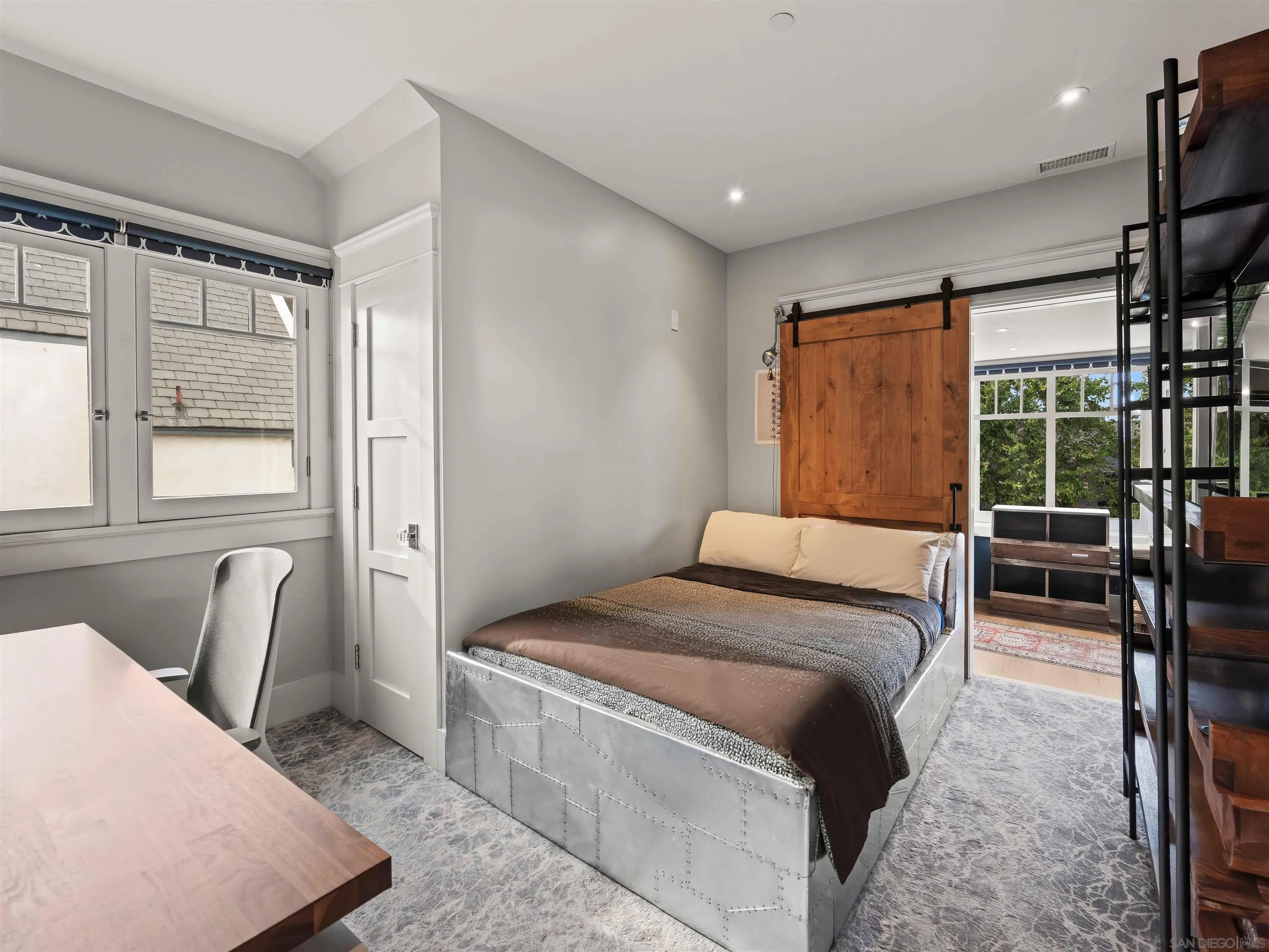 1027 G Avenue Coronado, CA 92118 - Photo 48 of 59 a bedroom with a bed and wooden floor