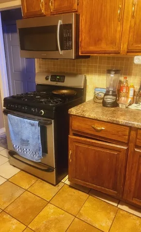 a stove top oven sitting inside of a kitchen