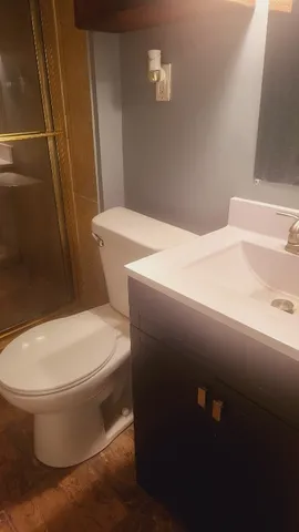 a white toilet sitting next to a bathroom sink
