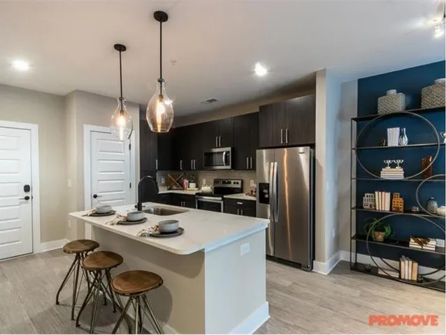 a kitchen with refrigerator cabinets and furniture