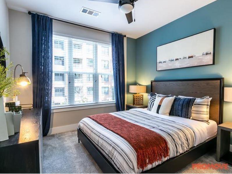 2855 Crescent Parkway, Unit 731 Atlanta, GA 30339 - Photo 4 of 6 a bedroom with a large bed and a large window