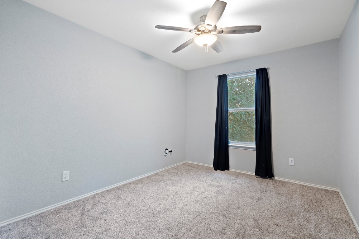 8609 Claude Court Austin, TX 78747 - Photo 11 of 30 an empty room with closet and a ceiling fan