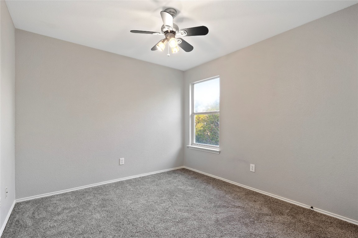 8609 Claude Court Austin, TX 78747 - Photo 12 of 30 an empty room with a window and a fan