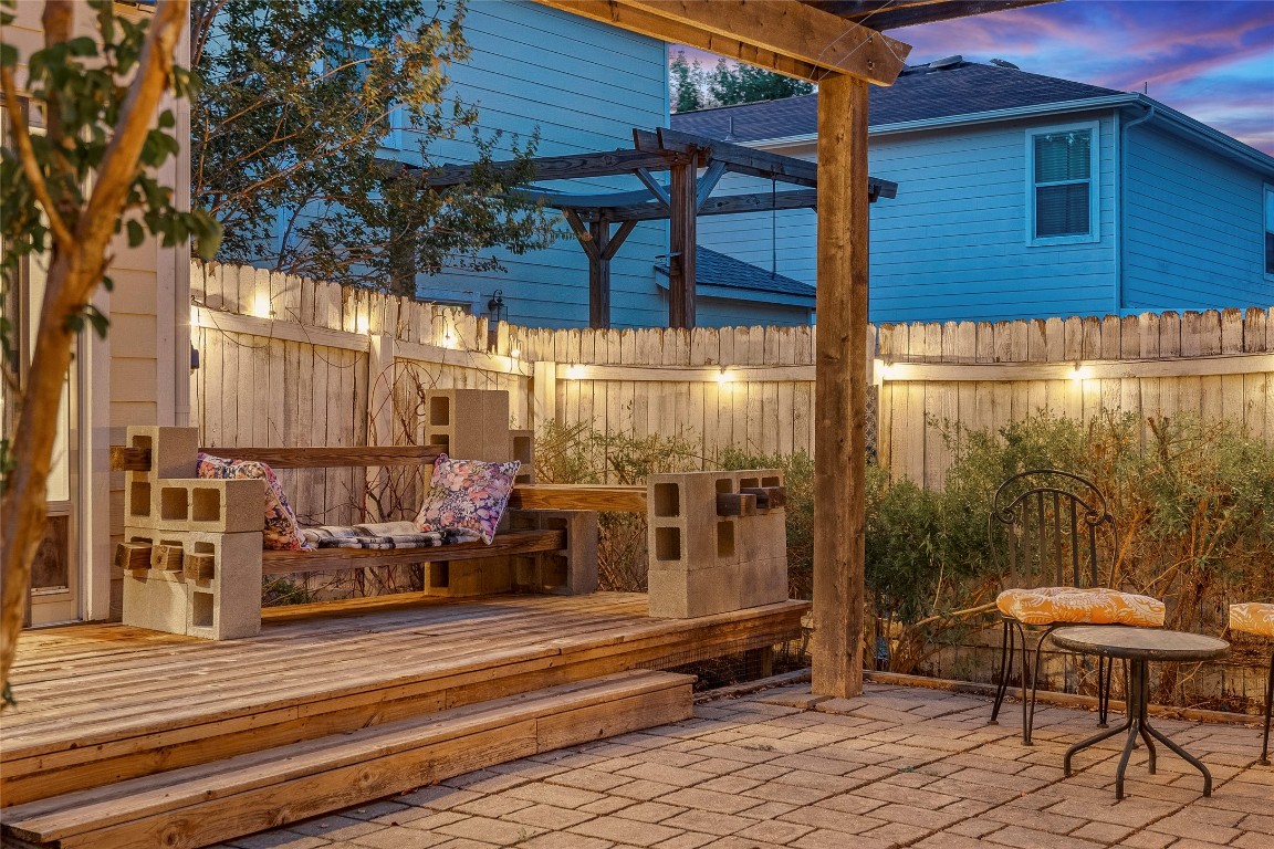 8609 Claude Court Austin, TX 78747 - Photo 14 of 30 a view of a patio with table and chairs with wooden floor and fence