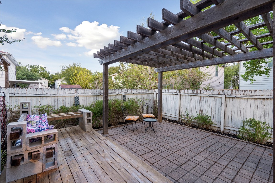 8609 Claude Court Austin, TX 78747 - Photo 25 of 30 a view of a patio with table and chairs potted plants with wooden floor and fence