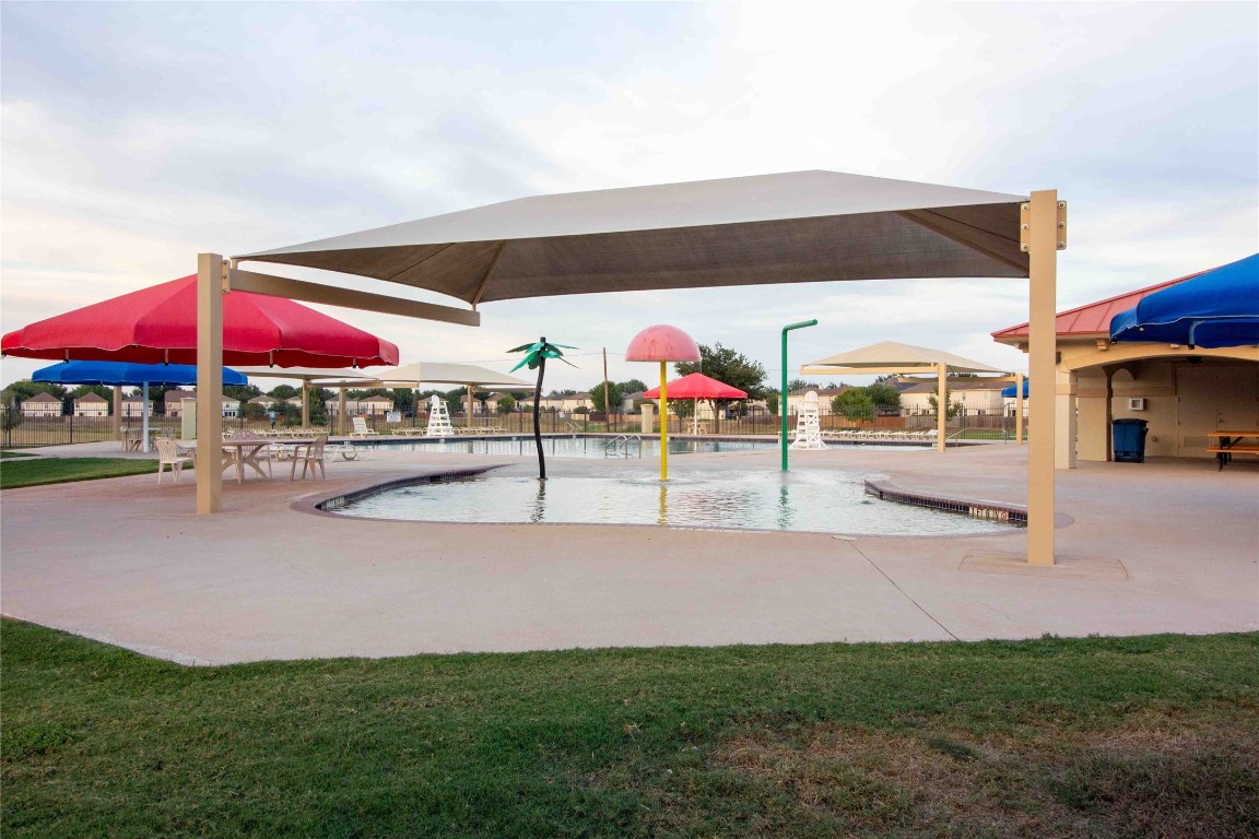 8609 Claude Court Austin, TX 78747 - Photo 26 of 30 a view of a patio with a table and chairs under an umbrella