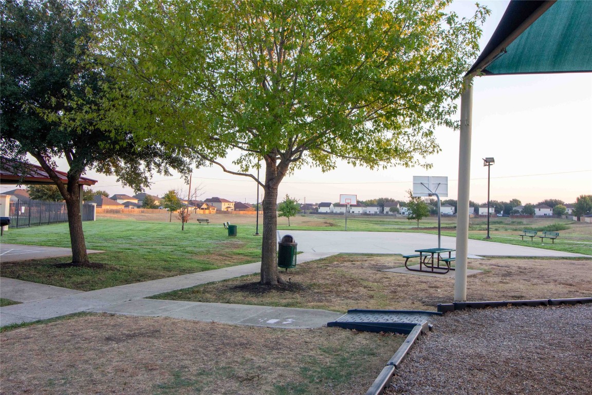 8609 Claude Court Austin, TX 78747 - Photo 29 of 30 a park with large trees and a lake view