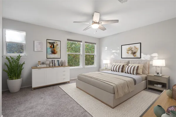 a spacious bedroom with a large bed and a chandelier