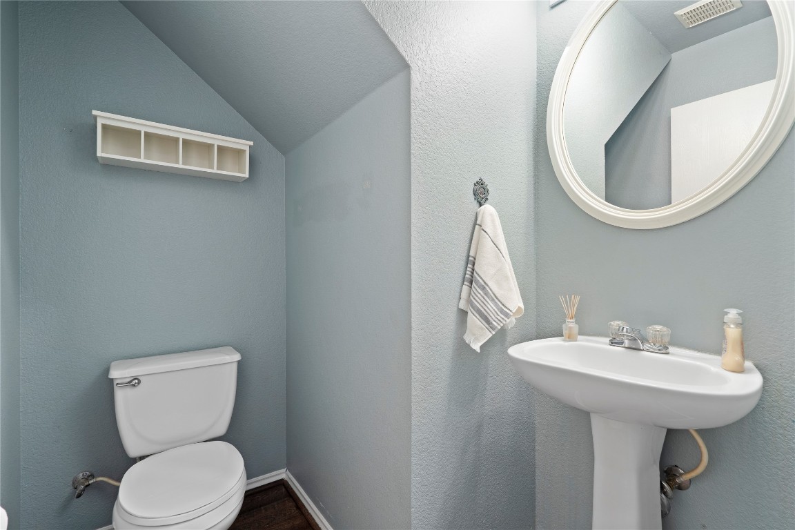 8609 Claude Court Austin, TX 78747 - Photo 9 of 30 a bathroom with a toilet sink and mirror