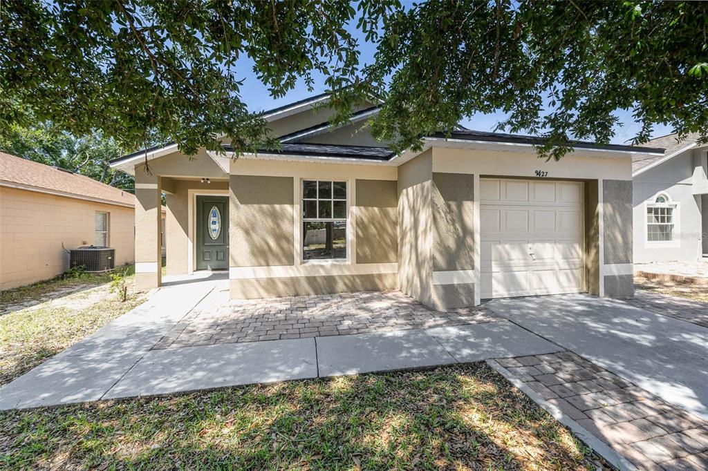 9427 Azalea Ridge Way Gotha, FL 34734 - Photo 1 of 1 a front view of a house with a yard and garage