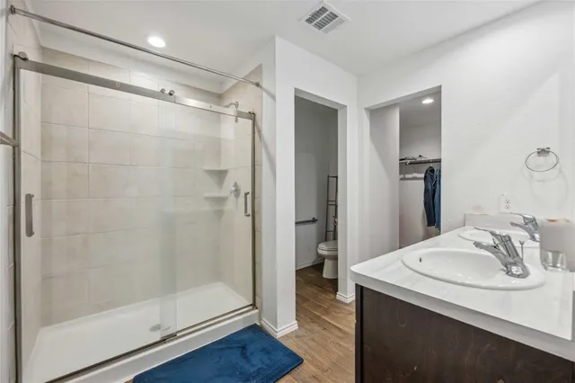 a bathroom with a shower sink and mirror