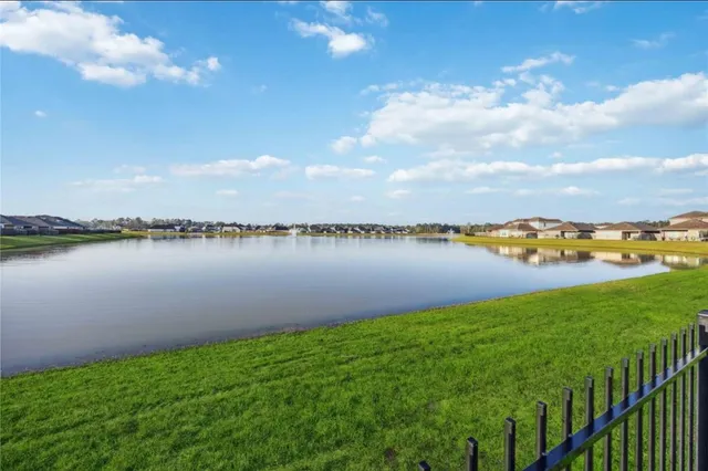 a view of a lake with houses in the back