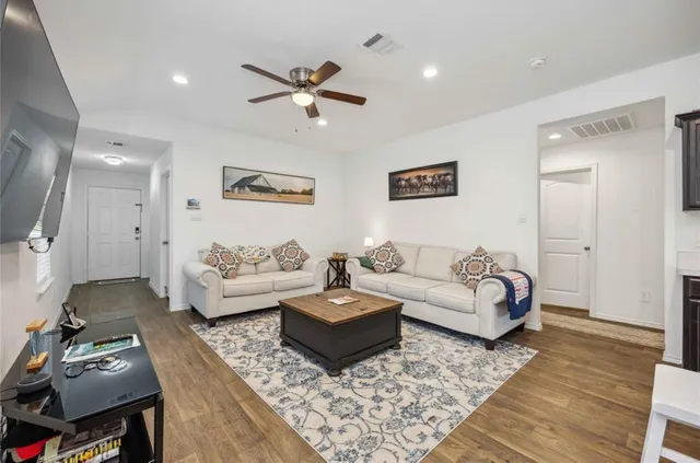 a living room with furniture and a rug