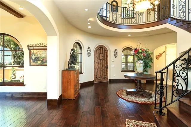 a view of a livingroom with furniture wooden floor and windows
