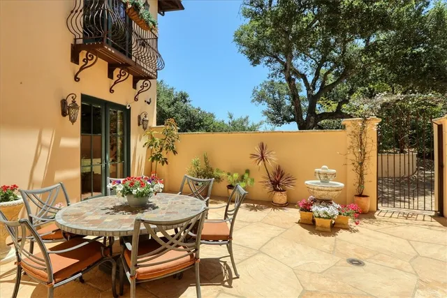 a spacious bedroom with a balcony a bed and a flat screen tv