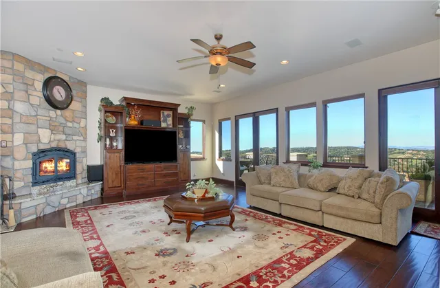 a living room with furniture a rug and a fireplace