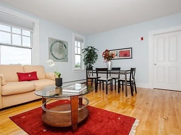 a living room with furniture a window and a dining table