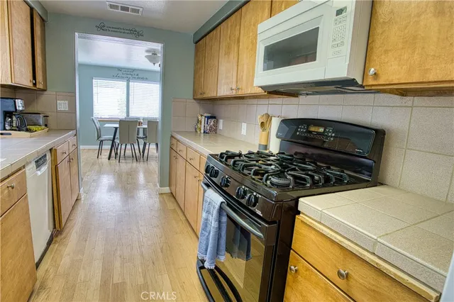 a kitchen with counter top space cabinets and stainless steel appliances