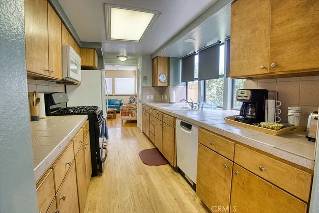 a kitchen with a sink and a stove top oven
