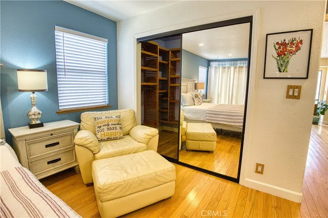 a bathroom with a double vanity sink a large mirror and a bathtub