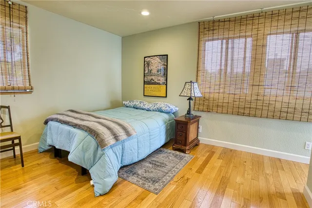 a bathroom with a granite countertop toilet a sink and a mirror