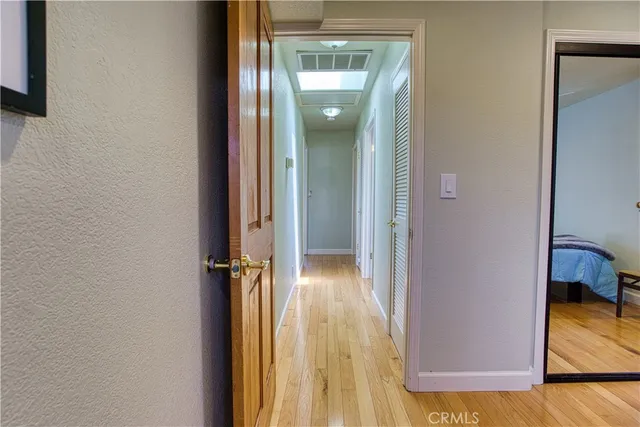 a spacious bedroom with a bed and a lamp