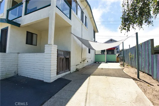 a view of a patio with table and chairs with wooden floor and fence