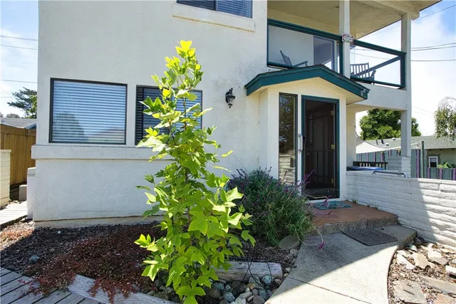 a front view of a house with a flower garden