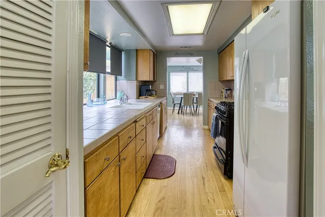 a open kitchen with stainless steel appliances granite countertop a sink and cabinets