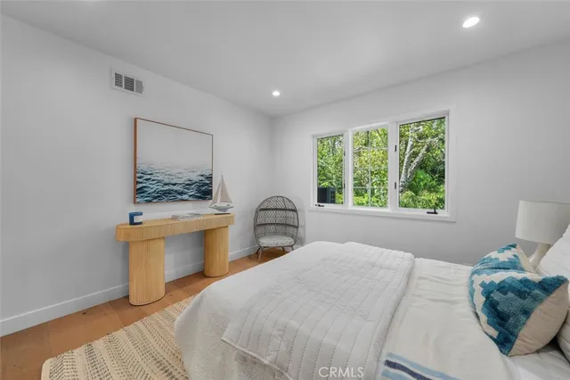 a bedroom with a large bed and a window