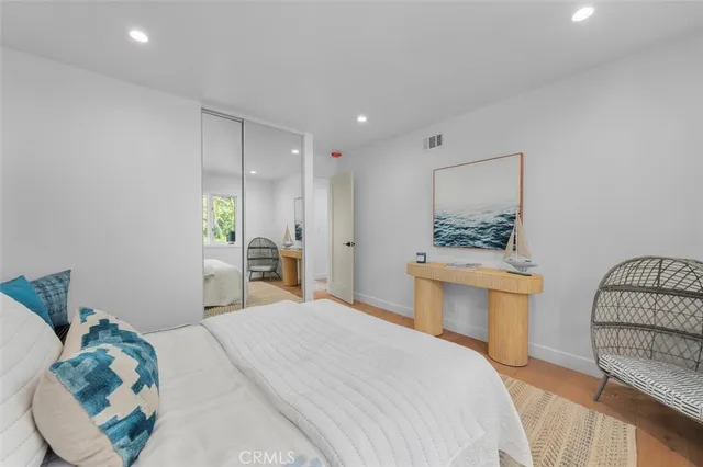 a bedroom with a bed and a mirror