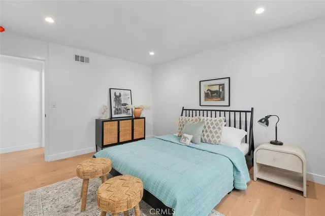 a bedroom with a large bed and a couch