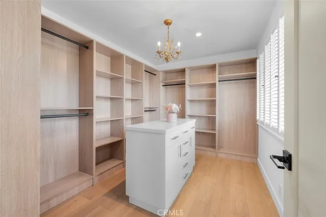 a storage room with wooden floor and windows