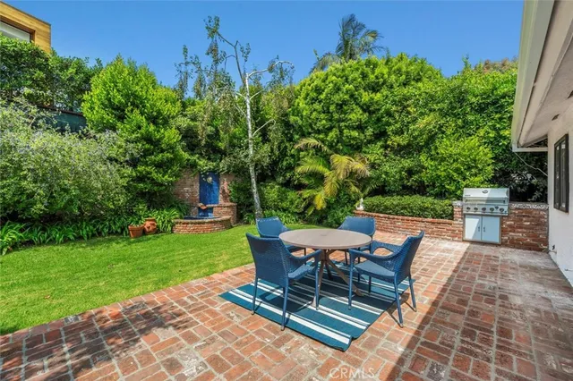a view of a backyard with sitting area