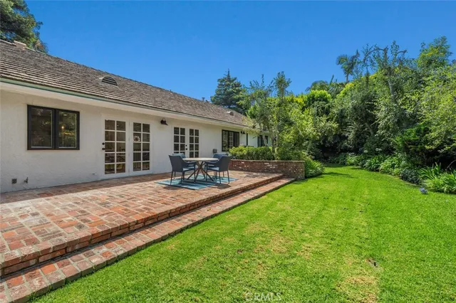 a view of a backyard with sitting area