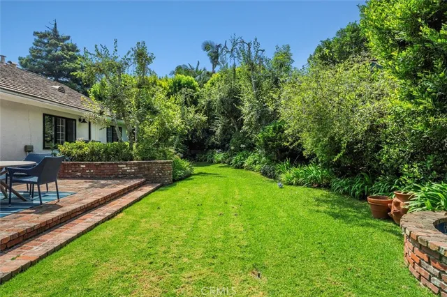 a view of a backyard with sitting area