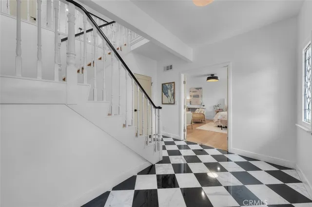 a view of a hallway with a black and white checkered floor