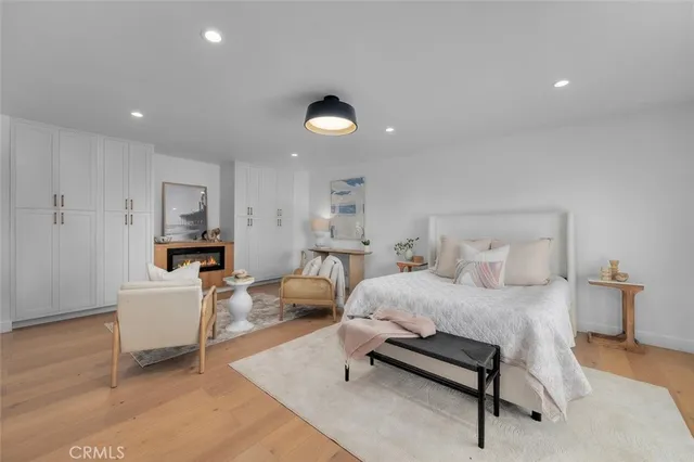 a bedroom with furniture and a wooden floor
