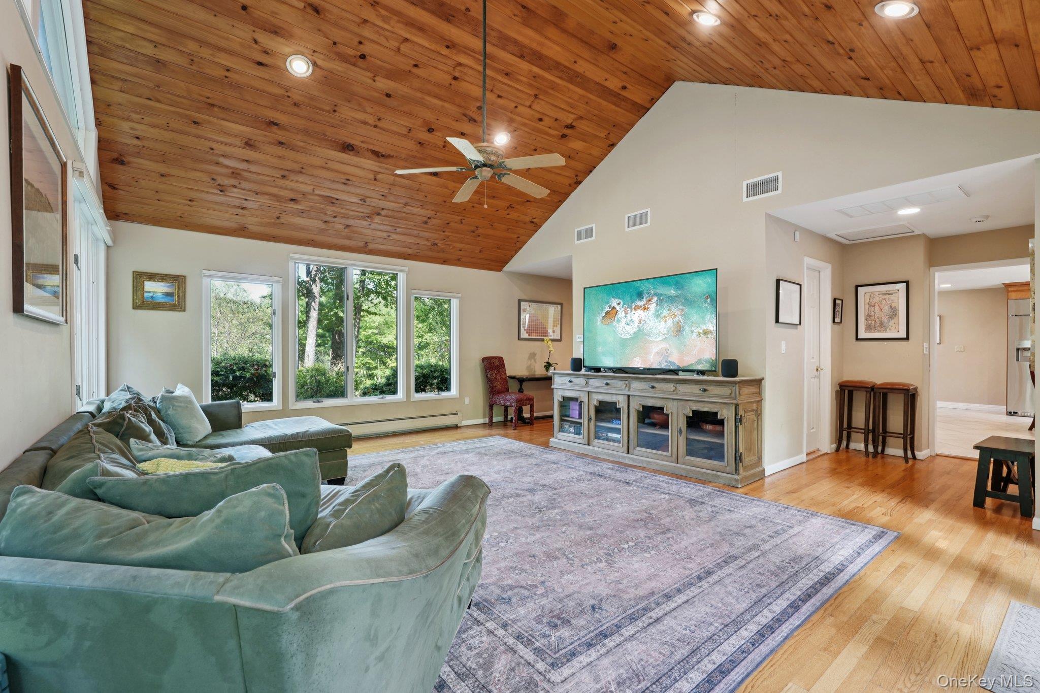 11 Old Phillips Hill Road New City, NY 10956 - Photo 14 of 42 a living room with furniture and a flat screen tv with wooden floor