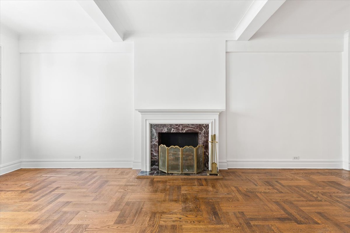 a view of an empty room with a fireplace