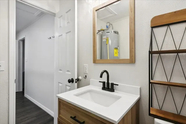 a bathroom with a sink a mirror and a window