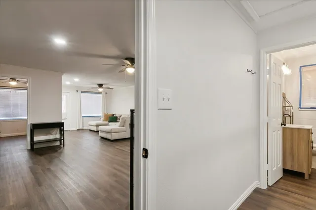 a view of living room with furniture and wooden floor