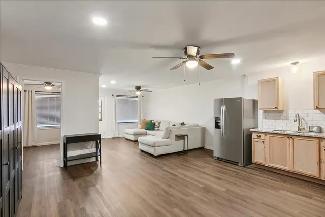 a living room with furniture and kitchen view