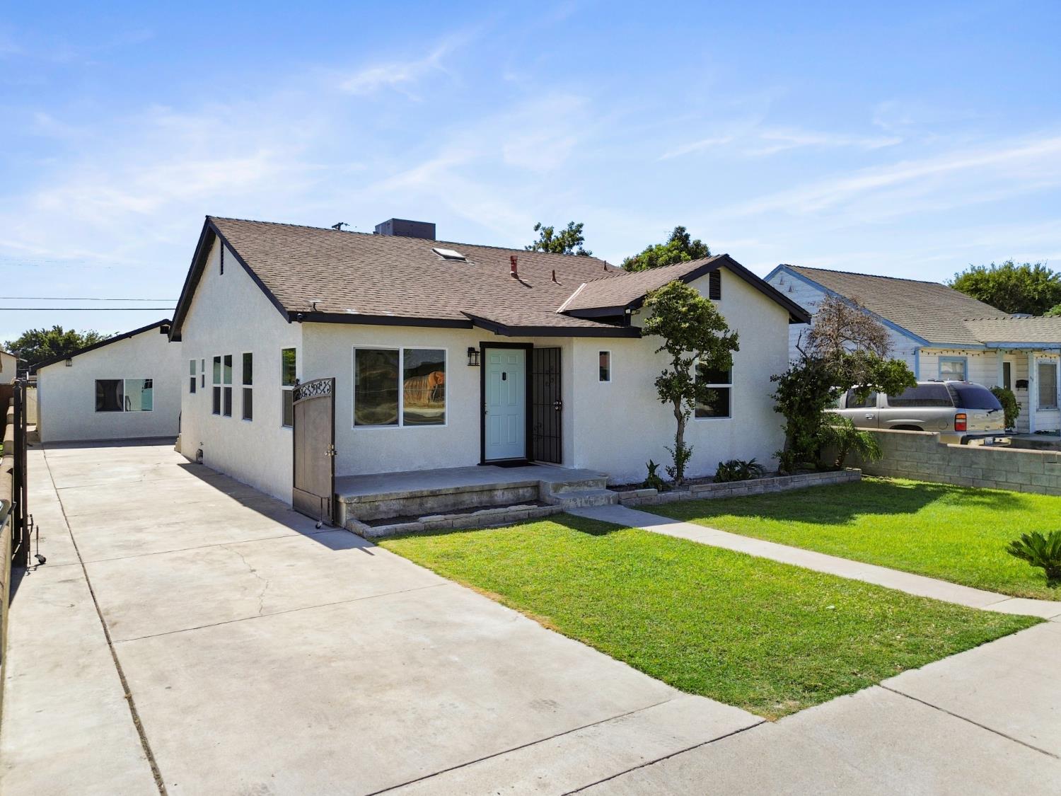 513 Decatur Street Bakersfield, CA 93308 - Photo 1 of 1 a front view of a house with a yard and swimming pool