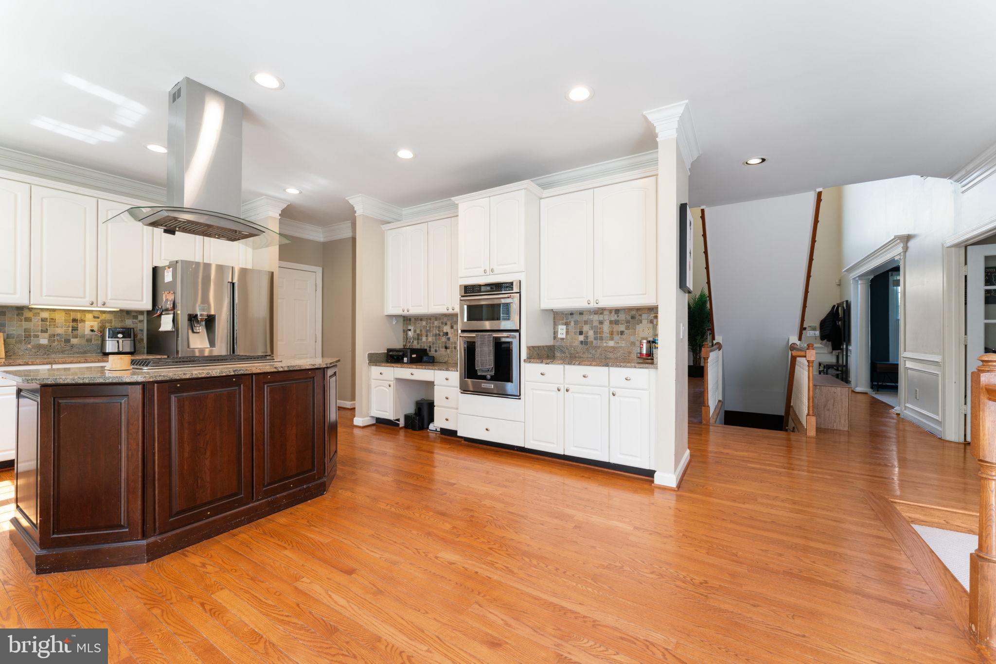 2113 Arrowleaf Drive Vienna, VA 22182 - Photo 11 of 40 a kitchen with stainless steel appliances a refrigerator and a wooden cabinets