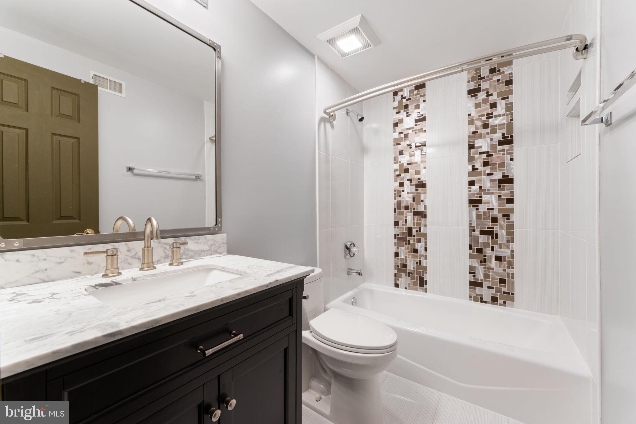 2113 Arrowleaf Drive Vienna, VA 22182 - Photo 25 of 40 a bathroom with a sink a toilet and shower